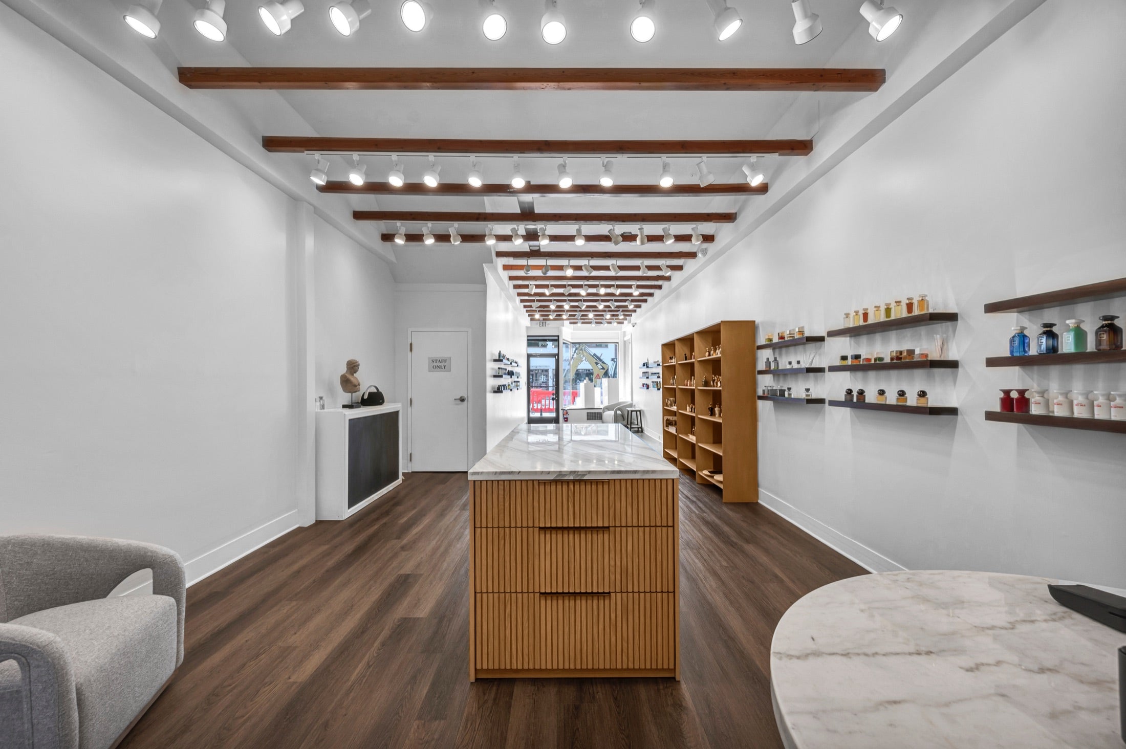 Xtrait Perfumery boutique island and fragrance shelves
