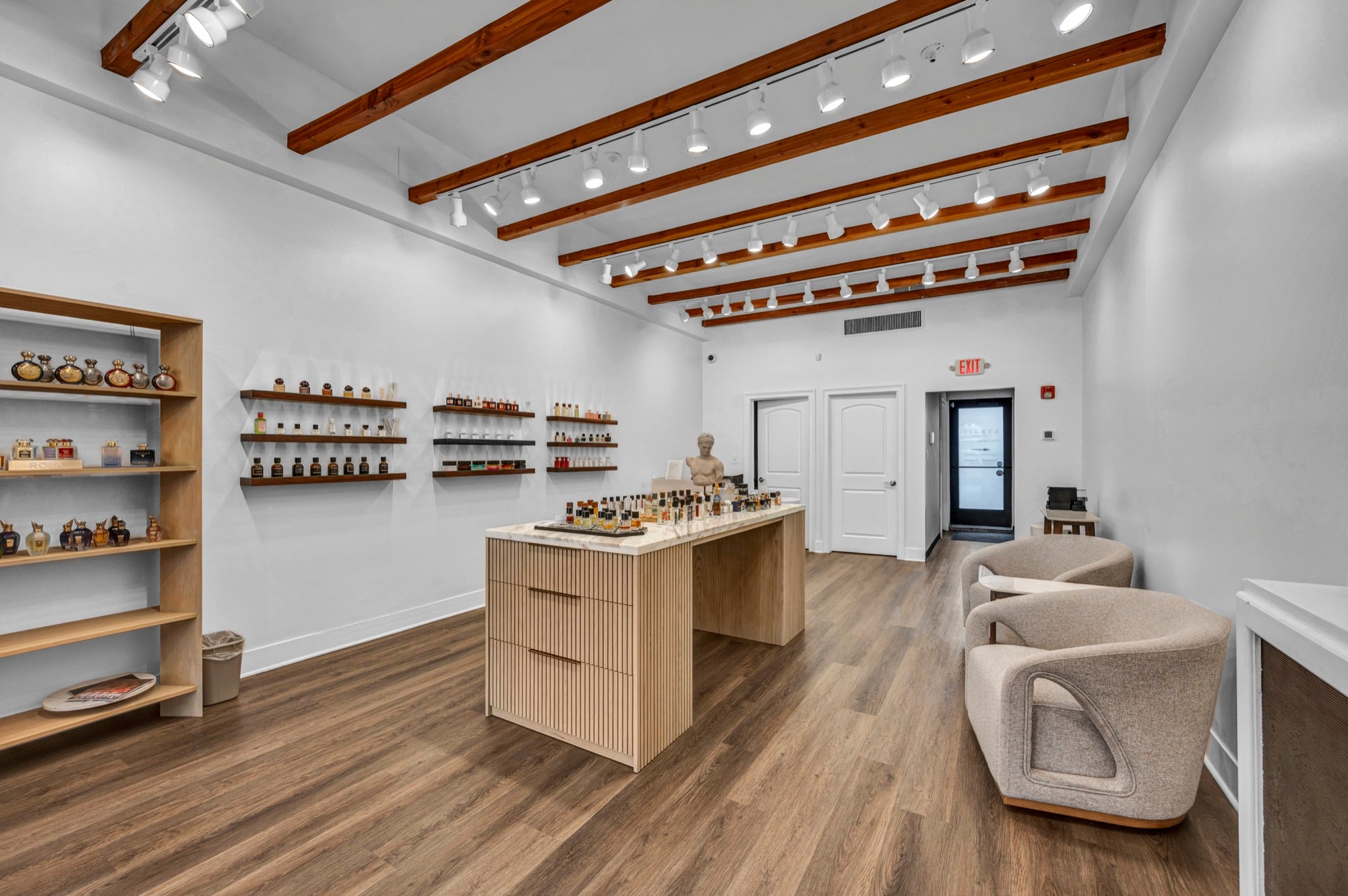 Xtrait Perfumery boutique interior with the central island and fragrance shelves in West Hartford, CT